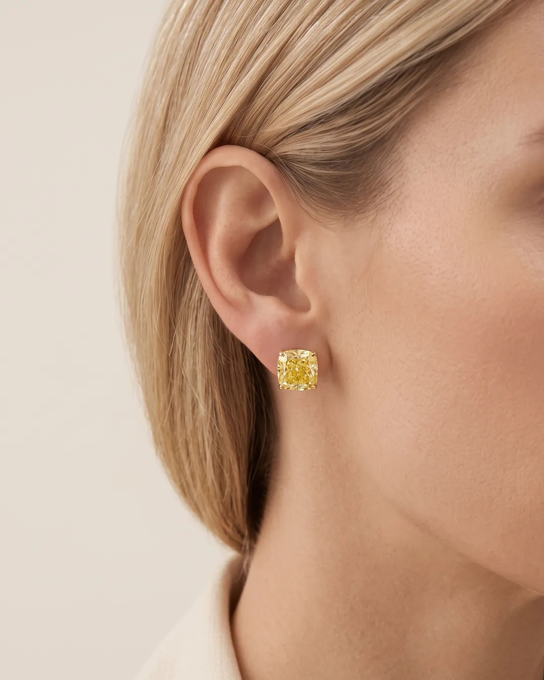 ORTIGAS Yellow Cushion Studs earrings, worn on the ear